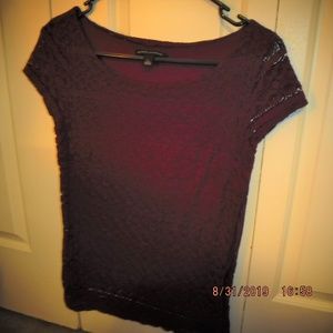 Purple short-sleeved top with design thoughout